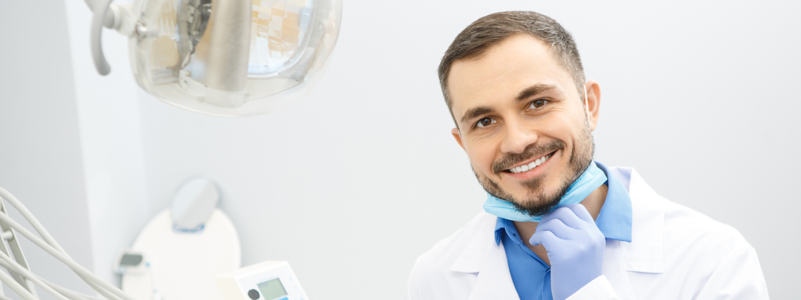 ACDQ young smiling dentist